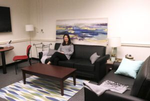 UX Lab Manager Songhee Kim sits on a couch in part of the Message Effects room, which is available for user research.